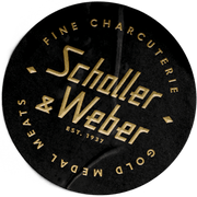 Black badge with "Schaller & Weber est. 1937 logo, Fine Charcuterie, Gold Medal Meats" in gold writing