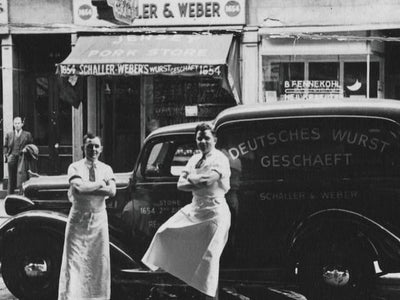 Schaller & Weber crew leaning against vintage delivery car
